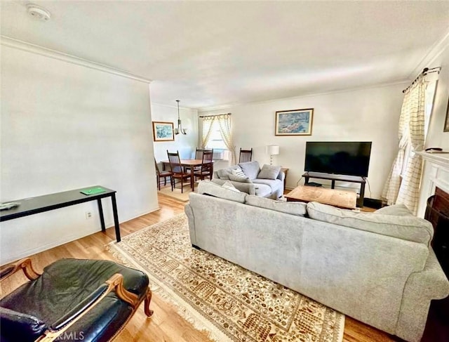 living room featuring a brick fireplace, wood finished floors, and crown molding