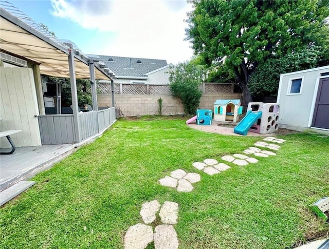 view of yard featuring a pergola, a playground, and a fenced backyard