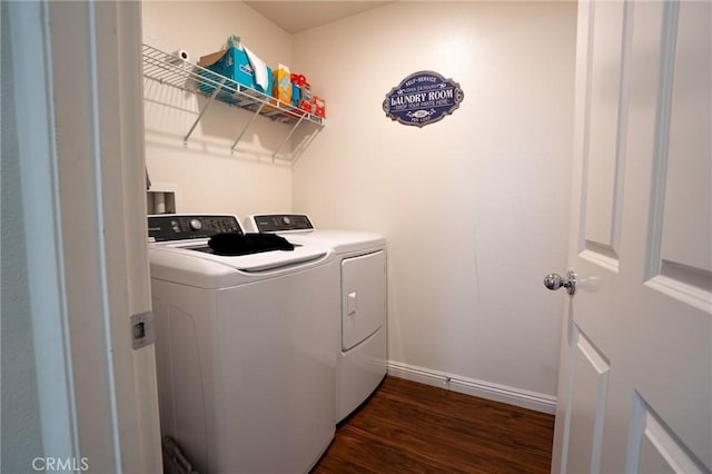 laundry area with laundry area, baseboards, dark wood-style floors, and washer and clothes dryer