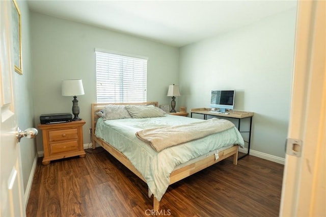 bedroom featuring dark wood-style floors and baseboards