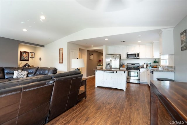 living room with lofted ceiling, dark wood-type flooring, and recessed lighting