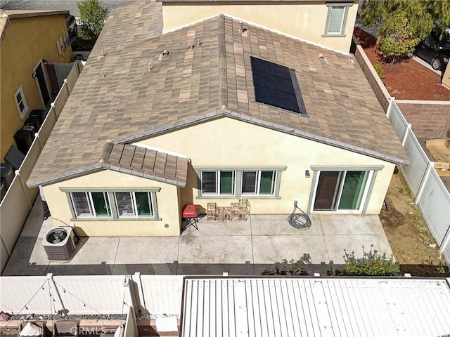 back of property featuring a fenced backyard, a patio, central AC, and stucco siding