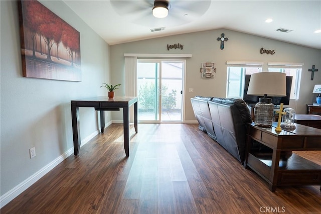 living area with visible vents, vaulted ceiling, and dark wood-style flooring