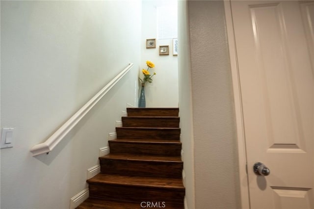 staircase with wood finished floors