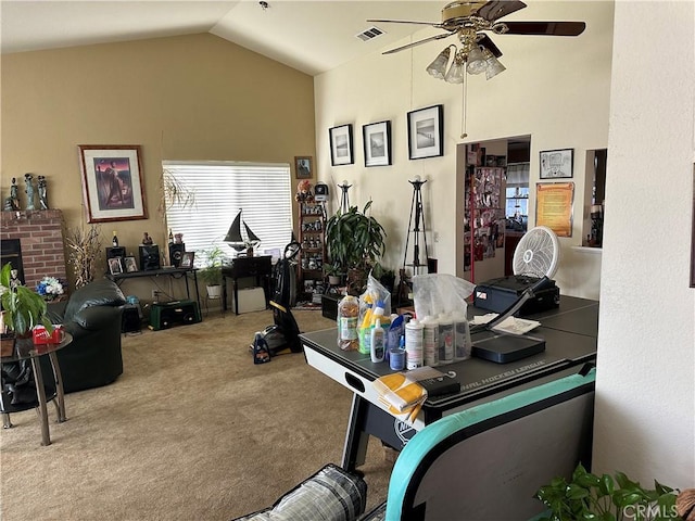 home office featuring vaulted ceiling, carpet floors, visible vents, and a ceiling fan