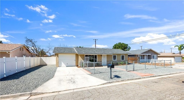 ranch-style house featuring a garage, a fenced front yard, concrete driveway, and stucco siding