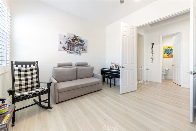 sitting room with baseboards and wood finished floors