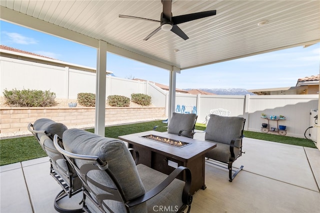 view of patio with a fire pit, ceiling fan, and a fenced backyard