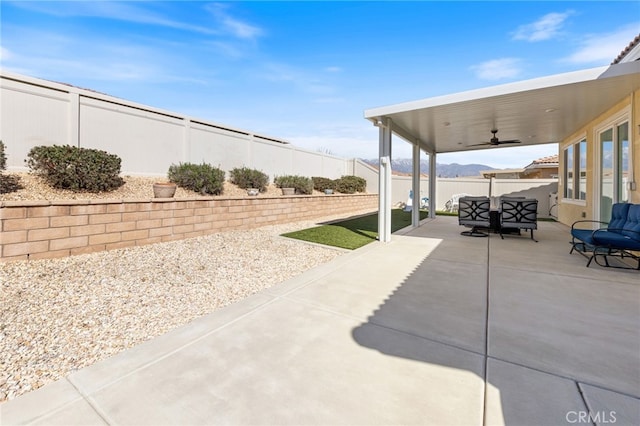 view of patio featuring a fenced backyard and ceiling fan