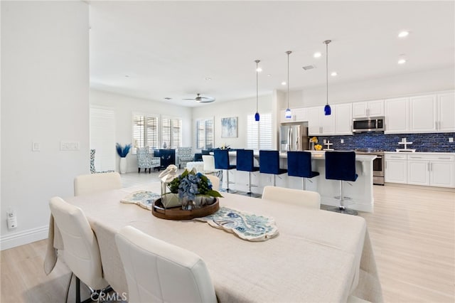 dining space with light wood-type flooring, baseboards, visible vents, and recessed lighting