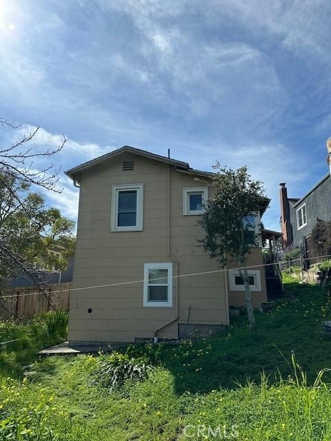 view of side of home with fence