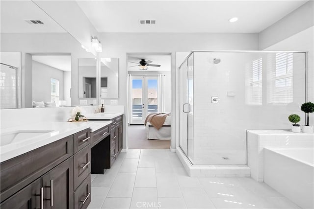 bathroom with visible vents, a bath, tile patterned floors, double vanity, and a stall shower