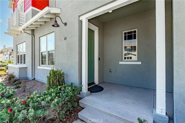 entrance to property with stucco siding