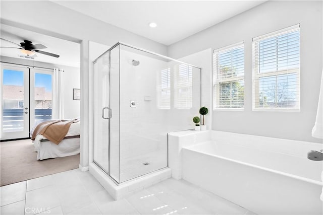 ensuite bathroom featuring a stall shower, a healthy amount of sunlight, a garden tub, and ensuite bathroom