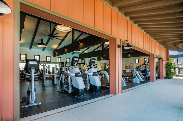 exercise room featuring high vaulted ceiling