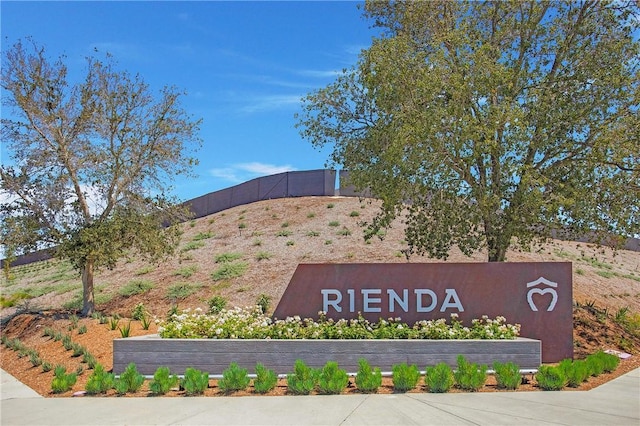 community / neighborhood sign featuring fence