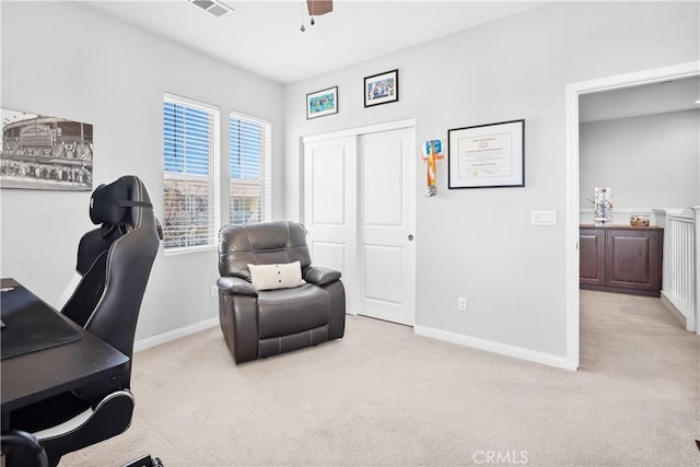 carpeted office space featuring a ceiling fan, visible vents, and baseboards