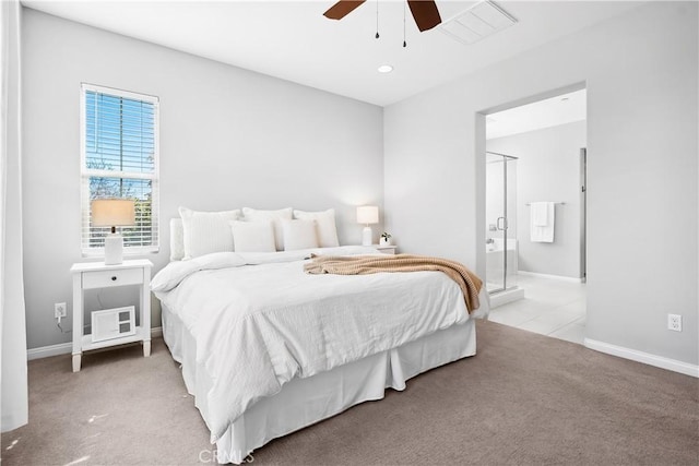 bedroom with carpet floors, ensuite bath, baseboards, and a ceiling fan