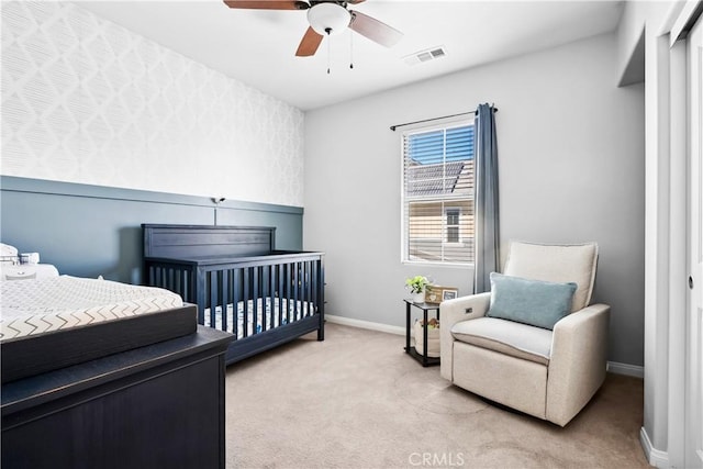 bedroom featuring light carpet, baseboards, visible vents, and ceiling fan