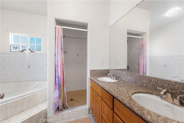 full bathroom featuring a tile shower, a sink, and a garden tub