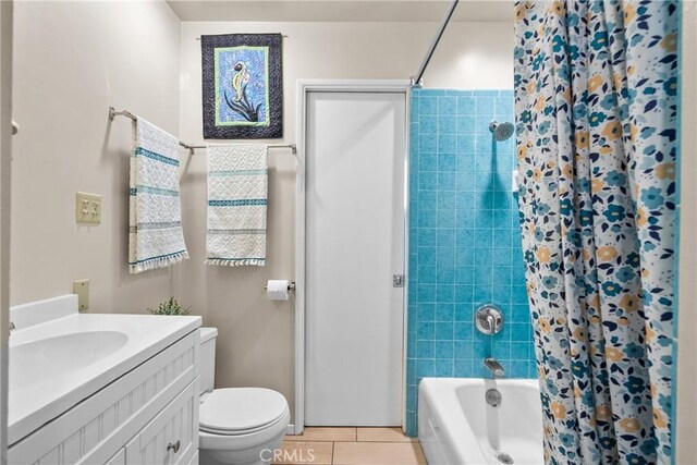 full bath with tile patterned flooring, shower / tub combo, toilet, and vanity