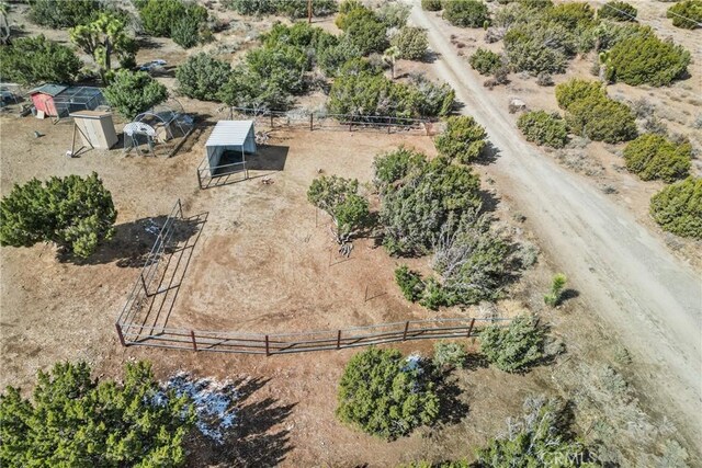 birds eye view of property with a rural view