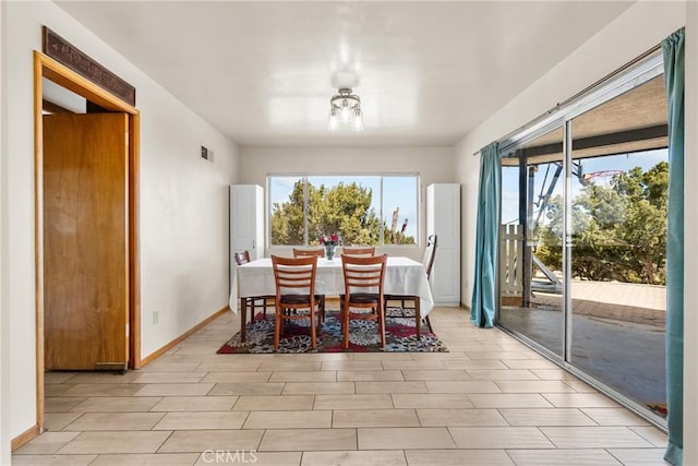 dining room with wood finish floors, visible vents, and baseboards