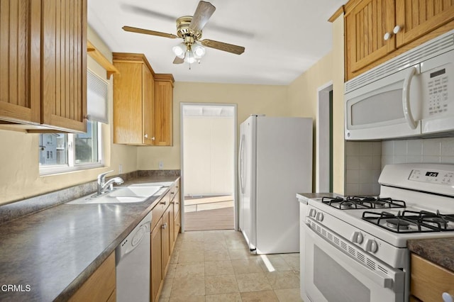 kitchen with tasteful backsplash, dark countertops, a sink, ceiling fan, and white appliances