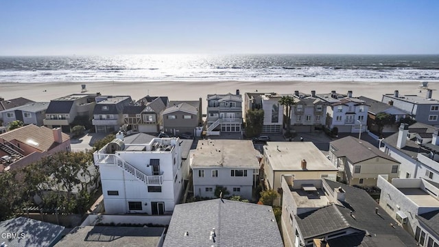 birds eye view of property with a view of the beach, a residential view, and a water view