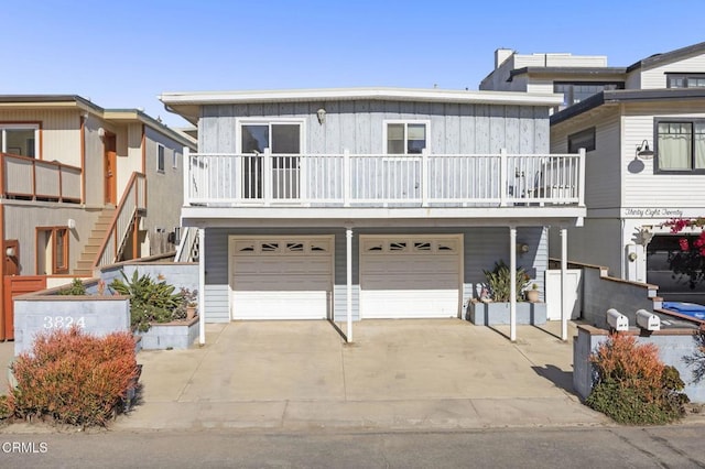 view of front of house featuring driveway, stairs, a garage, and board and batten siding