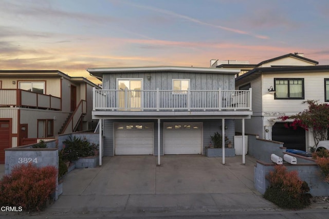 view of front of home featuring a garage, stairs, and concrete driveway