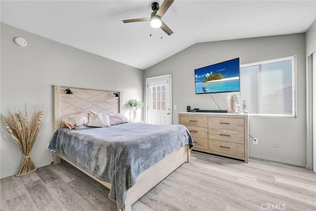 bedroom with vaulted ceiling, light wood-style flooring, baseboards, and ceiling fan