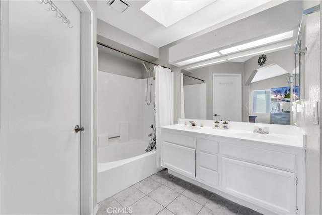 bathroom featuring a skylight, visible vents, a sink, and shower / bathtub combination with curtain