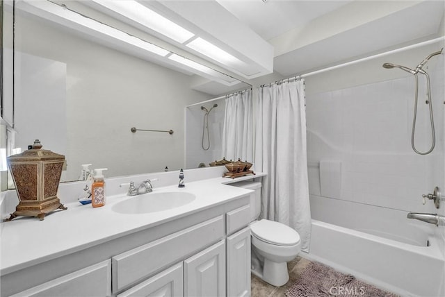 bathroom with shower / bath combo with shower curtain, vanity, and toilet