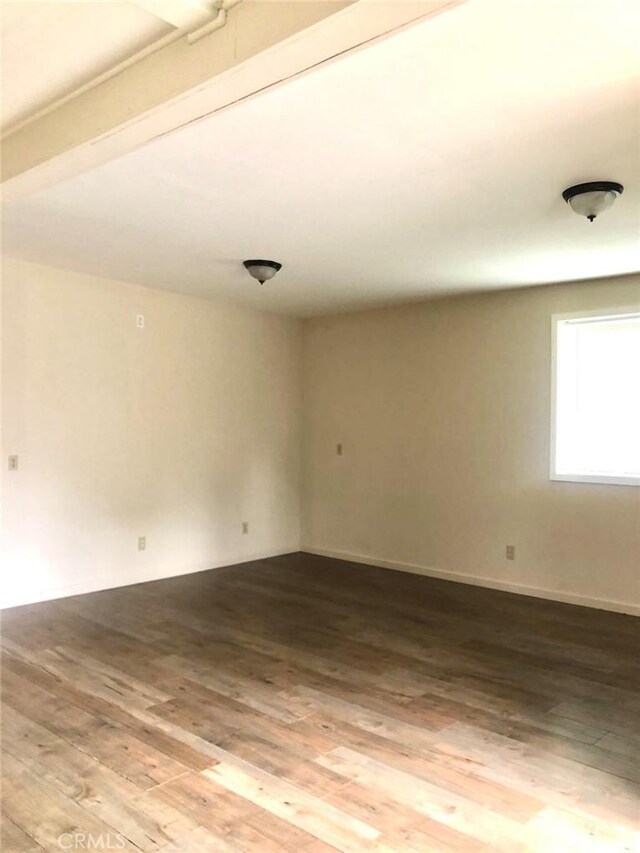 spare room with wood finished floors