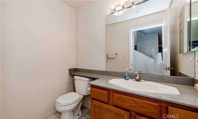 bathroom featuring tile patterned flooring, vanity, toilet, and baseboards