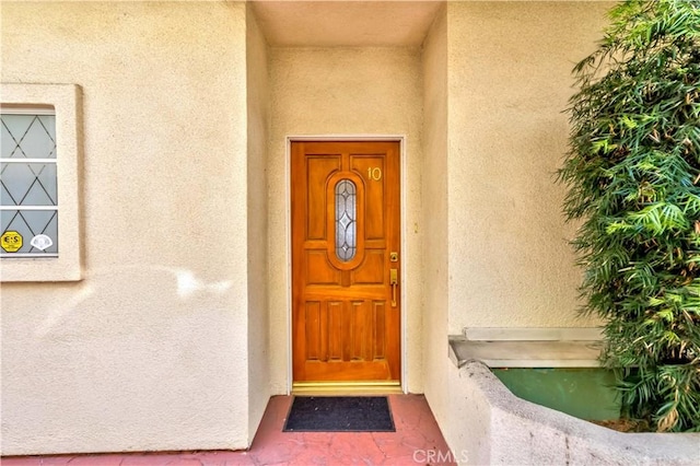 entrance to property featuring stucco siding