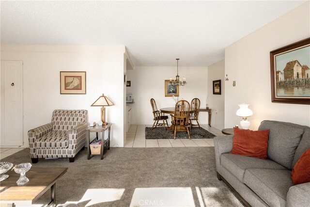 living room featuring a chandelier, carpet flooring, and tile patterned floors