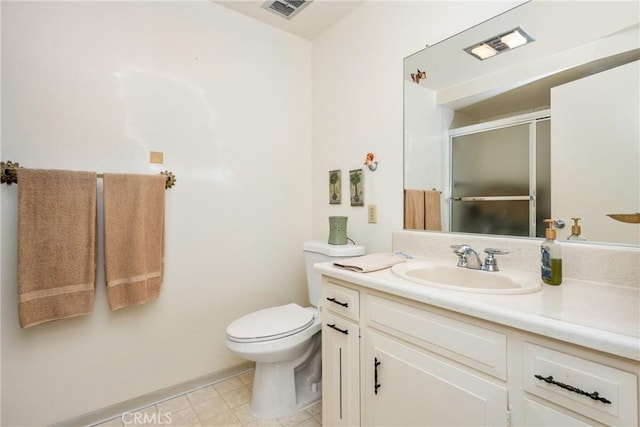 bathroom featuring toilet, a stall shower, visible vents, and vanity