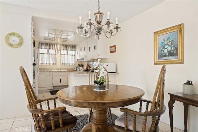 dining area with a textured ceiling and light tile patterned floors