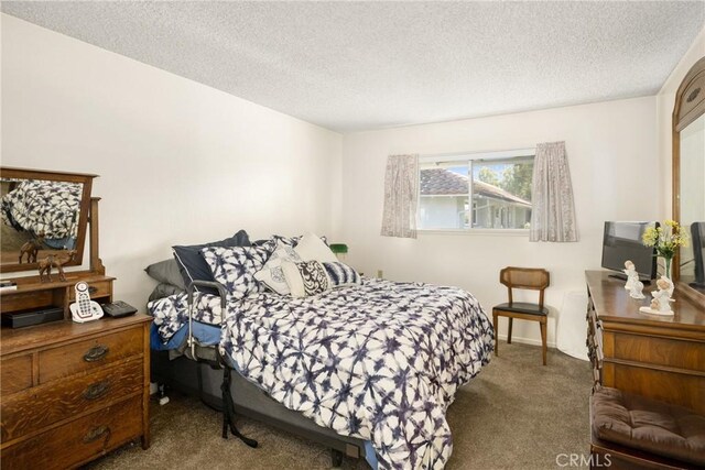 carpeted bedroom with a textured ceiling