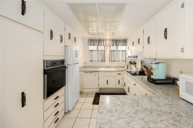 660 Avenida Sevilla Unit P, Laguna Woods, CA 92637 - kitchen featuring black appliances, light countertops, white cabinetry, and light tile patterned flooring