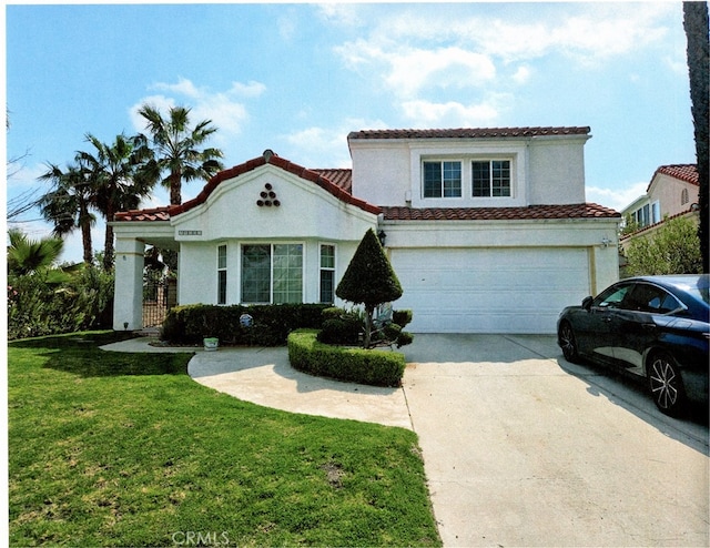 mediterranean / spanish house with stucco siding, concrete driveway, a front yard, an attached garage, and a tiled roof