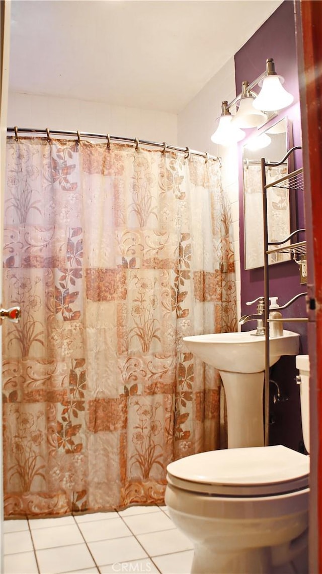 full bathroom with toilet, tile patterned flooring, and a shower with shower curtain