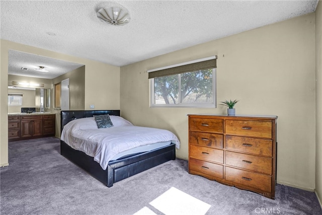 bedroom featuring a textured ceiling and carpet floors