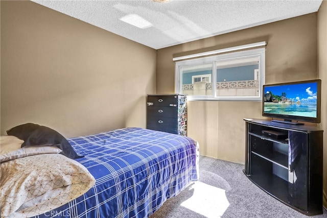 bedroom featuring carpet flooring, a textured ceiling, and baseboards