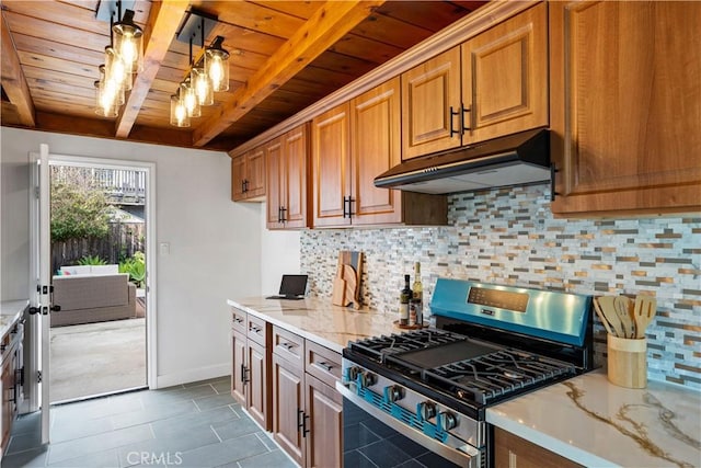 kitchen featuring beam ceiling, tasteful backsplash, stainless steel gas range, wooden ceiling, and under cabinet range hood