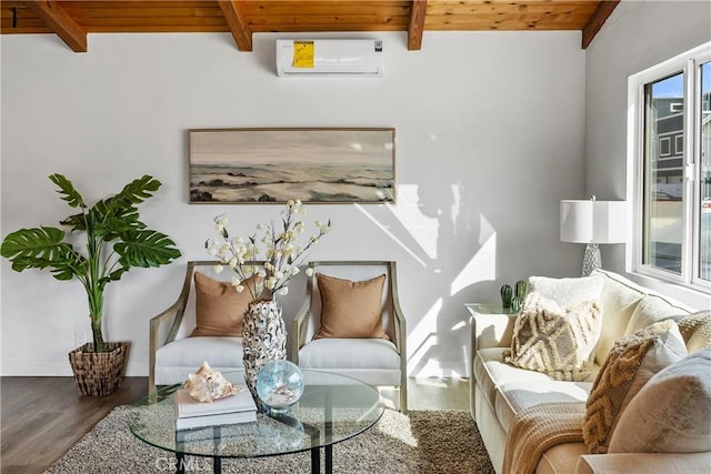 sitting room featuring wood finished floors, wood ceiling, baseboards, an AC wall unit, and beam ceiling