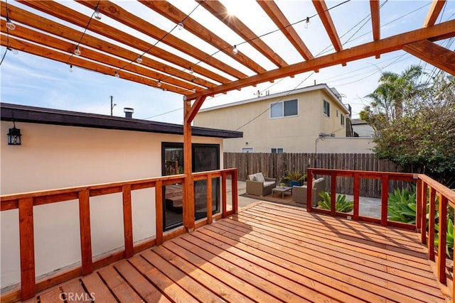 wooden deck with outdoor lounge area and fence