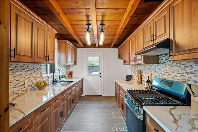 kitchen featuring stainless steel range with gas cooktop, wood ceiling, a sink, beamed ceiling, and under cabinet range hood